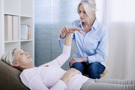 Senior woman undergoing hypnosis session