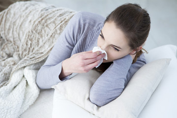 Woman blowing her nose