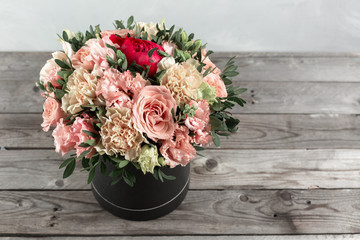 luxurious and elegant bouquet of roses and Other colors flowers on wooden background, copy space.