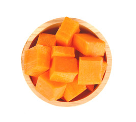 Carrot slices in a wooden bowl on a white background