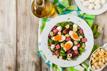 Delicious Italian salad with salami, egg, crostini and mozzarella.