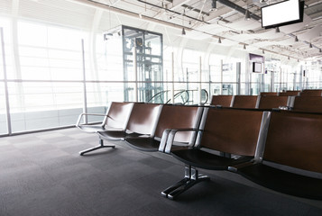empty airport terminal waiting area with chairs.