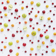 Cherries, apricot and green apples, plums isolated on white background.  Pattern of berries and fruits. Abstract food background. Berries and fruit top view.