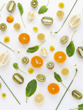 Orange slices,  lemon and kiwi on a white background. Fruit pattern. Abstract food background. Top view.