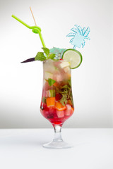 Glass of red ice tea with mint and lemon isolated