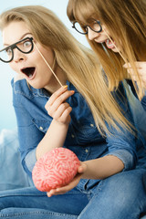 Two crazy women friends thinking