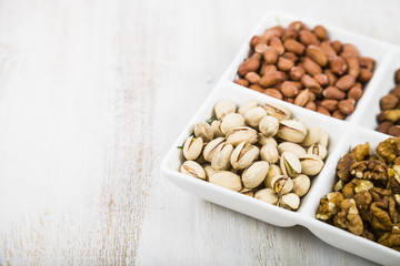 Bowl with nuts on a  wooden table