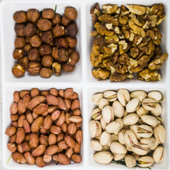 Bowl with nuts on a  wooden table