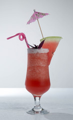 Piece of water melon on chopping board and in glass with ice isolated