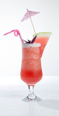 Piece of water melon on chopping board and in glass with ice isolated