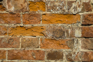 Fragment of a building with a collapsed brick wall.