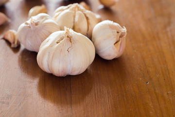 Garlic on wooden background.