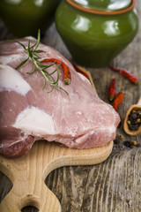 Raw pork on a wooden cutting board.