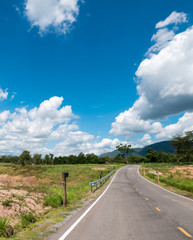 drive view of curve countryside road with mountain and sky