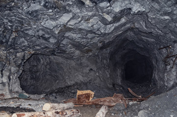 an abandoned mine tunnel in the mountains, stone catacombs