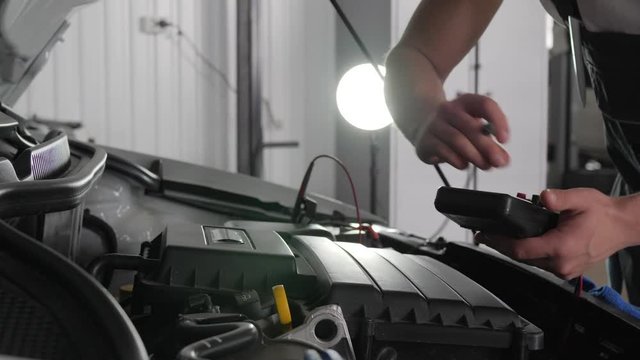 car service Close-up, open hood, mechanic's hands, in car workshop, check electrical wiring vehicle system, review engine and all automobile parts, Professional machine maintenance