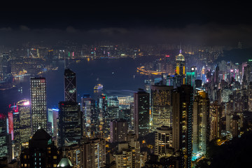 Aerial night view from Victoria peak to Kowloon bay and skyscrapers of Hong Kong island, China republic