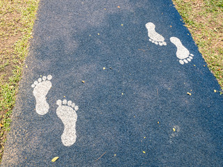 white footprints on blue path with grass