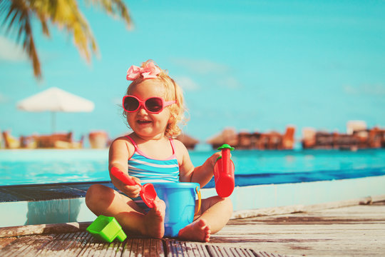 cute little girl playing on tropical beach