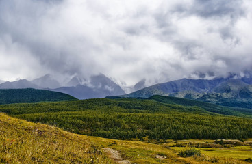 Fog in the mountains, the rocks in the fog, bad weather, rain, clouds in the mountains. Kyrgyzstan