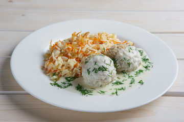 Plate with meatballs with rice and carrot.