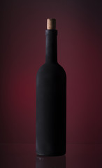 Pouring red wine into the glass against wooden background