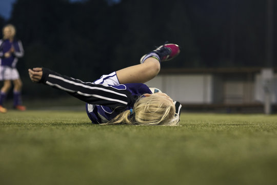 Surface level view of fallen athlete on soccer field