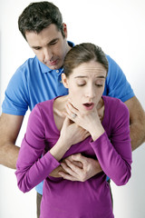 Fototapeta premium First aid techniques In case of choking, perform a maximum of 5 abdominal thrusts, also known as the Heimlich maneuver, to dislodge the article from the airway