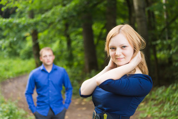 portrait beautiful young couple man woman quarreled background summer green park.