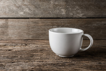 empty white cup on wooden background