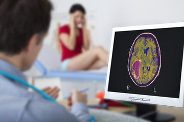 Models On screen, cerebral MRI showing a tumor (glioblastoma) - obrazy, fototapety, plakaty