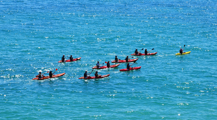 Naklejka premium Tourist kayak trip at beautiful shore near Praia do Pinhao, (Lagos at Algarve, Portugal
