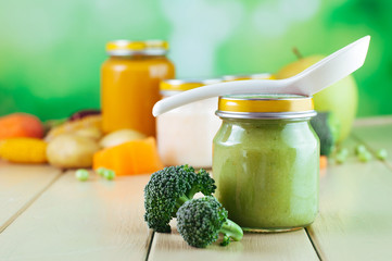 Natural broccoli baby food on the wooden background