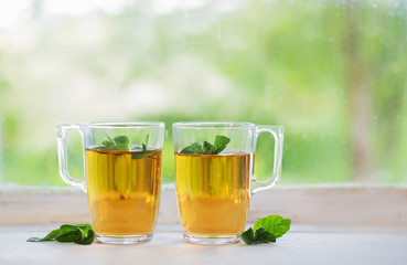 tea in glass cup on old  windowsill