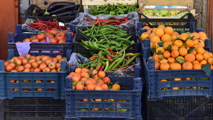 Organic mandarin, pepper, tomato, aubergine and apple in a public bazaar