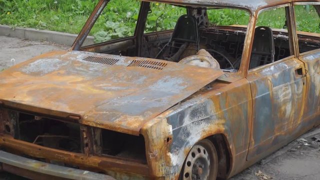 Burned car on city street. Chronicle of crime, slow motion hd video