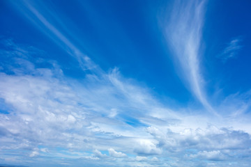 Blue sky background with white fluffy clouds.