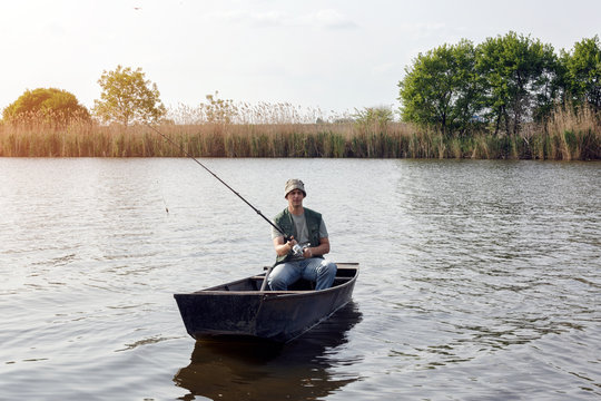 river fishing- man catching fish.