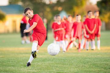 Kids soccer football - children players match on soccer field