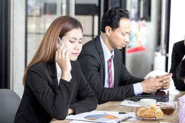 Asian Businesswoman  using phone for talking while meeting, woman working concept.