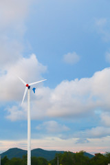 white wind turbine generating electricity on blue sky