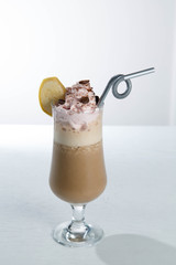 Glass of cold latte coffee topic cocolate cream on isolated white background with banana