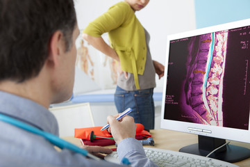 Models On screen, MRI of the vertebral column with arthrosis (colorized)