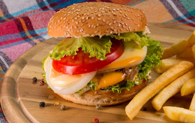 Burger and french fries on wooden table