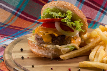 Burger and french fries on wooden table