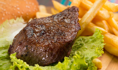 Grilled steak, French fries and vegetables
