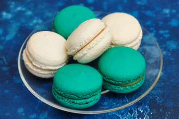 Cake macaron or macaroon on blue background, almond cookies