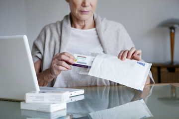 Senior woman receiving medicines bought on internet