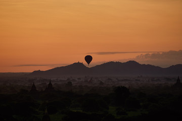 Hot air balloons hovering over pagodas in the ancient city of Bagan in myanmar