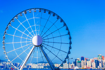 The Hong Kong observation (ferris) wheel on the Central overlooking Victoria harbour with blue sky as a background and copy space
